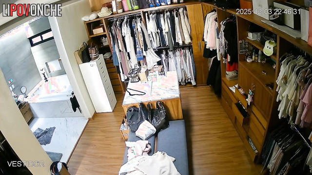 Hidden camera footage from a locker room showing a brunette undressing