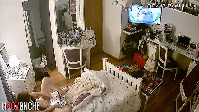 The redhead examines her wet pussy closely in the mirror, using her phone as a light