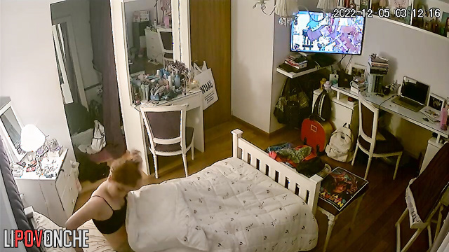 The redhead examines her wet pussy closely in the mirror, using her phone as a light