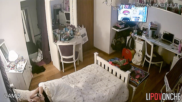 The redhead examines her wet pussy closely in the mirror, using her phone as a light