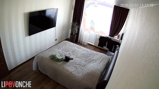 A hidden camera in the bedroom captured the chubby milf's ample breasts