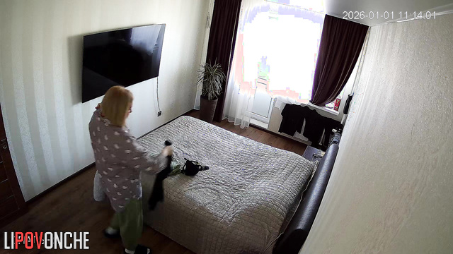 A hidden camera in the bedroom captured the chubby milf's ample breasts