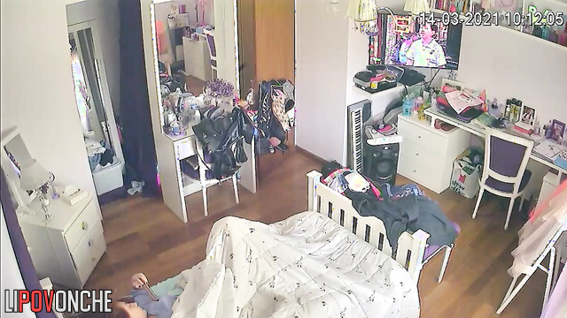 While watching a TV show, a pretty redheaded girl has an intense orgasm
