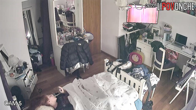 A girl with beautiful red hair is staring at the TV screen while having an orgasm