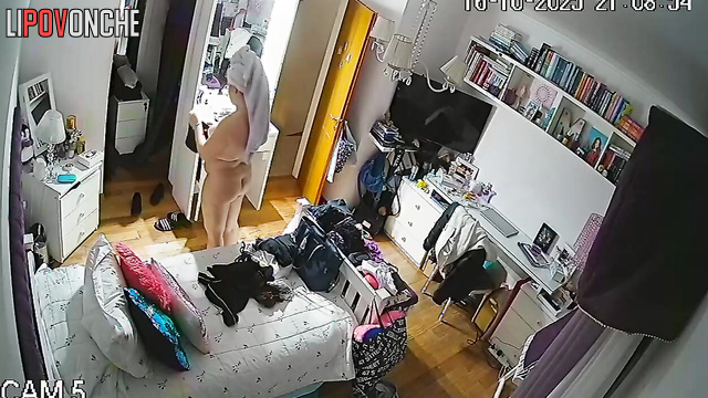 A naked beauty with a curvy butt walks around the room with her panties down
