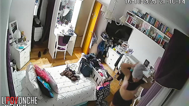 A naked beauty with a curvy butt walks around the room with her panties down