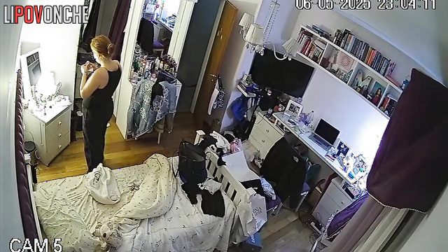 After undressing, the girl admires her new sexy black lingerie