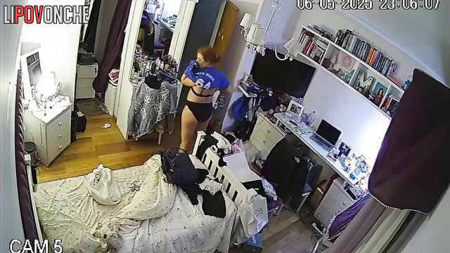 After undressing, the girl admires her new sexy black lingerie