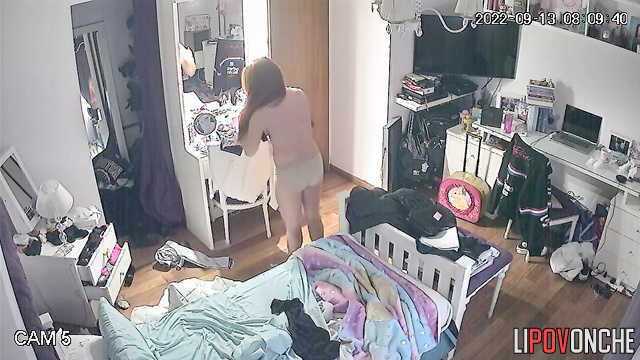 The red-haired beauty shyly hides her bare breasts from the milf