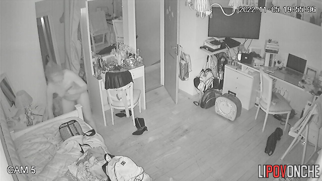 A young woman is talking on the phone with her friend while completely naked