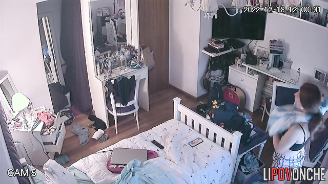 A red-haired girl in a sexy bra gazes lustfully at her reflection in the mirror
