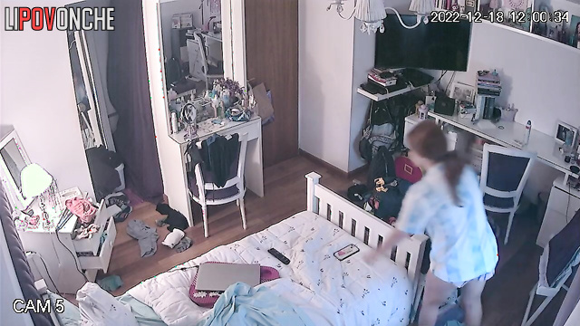 A red-haired girl in a sexy bra gazes lustfully at her reflection in the mirror