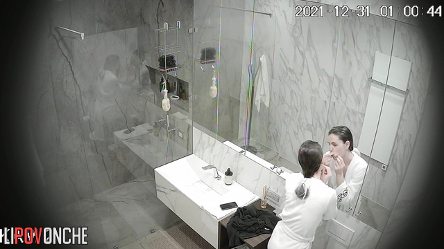 A hidden camera captured footage of a completely naked sporty girl taking a shower