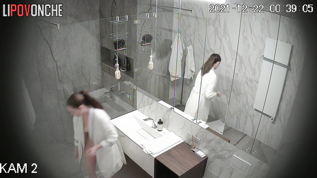 An athletic girl is vigorously lathering up her hairy pussy in the shower