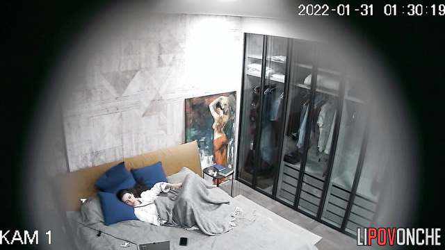 A bored girl masturbates in bed while her husband is at work