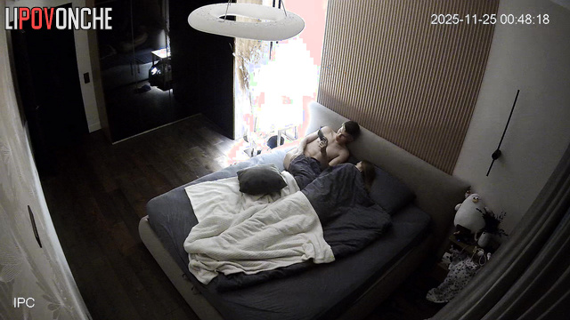 A naked, skinny girl caresses her buttocks before getting into bed