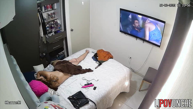 After playing a porn video on her phone, the naked brunette takes out her vibrator