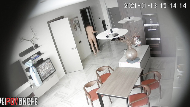 A fit housewife is bustling about in the kitchen completely naked