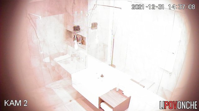 A fit beauty, completely naked, is tidying herself up in the bathroom