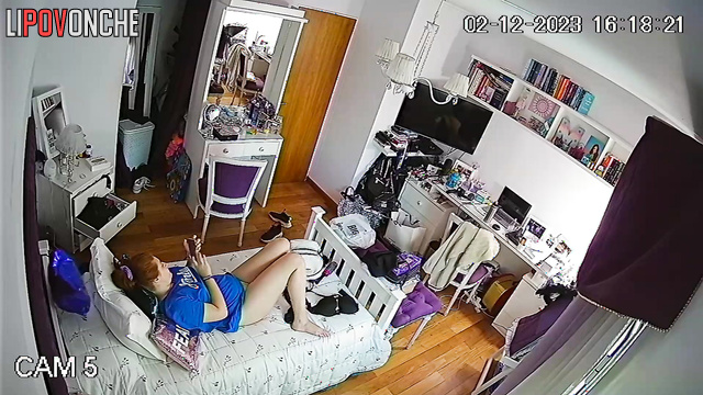 A red-haired cutie with a bare bottom pees into a cup right in her bedroom