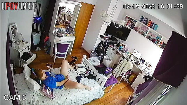 A red-haired cutie with a bare bottom pees into a cup right in her bedroom