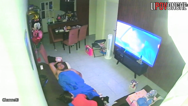 A horny mom plays with her bored husband's big cock while watching TV