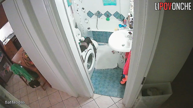 A cute girl with a seductive body strips completely naked in the bathroom