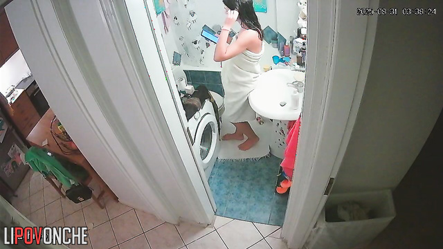 A cute girl with a seductive body strips completely naked in the bathroom