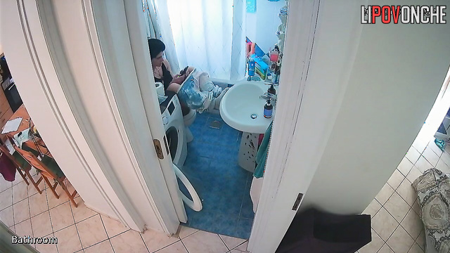 A sexy brunette arches seductively, washing her inviting butt