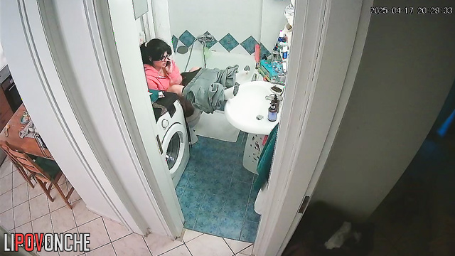 A girl, sitting on the toilet without panties, lifts her sexy legs high