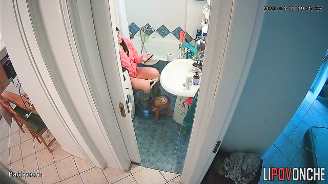 After pooping, a beautiful brunette washes her delicate, sexy ass