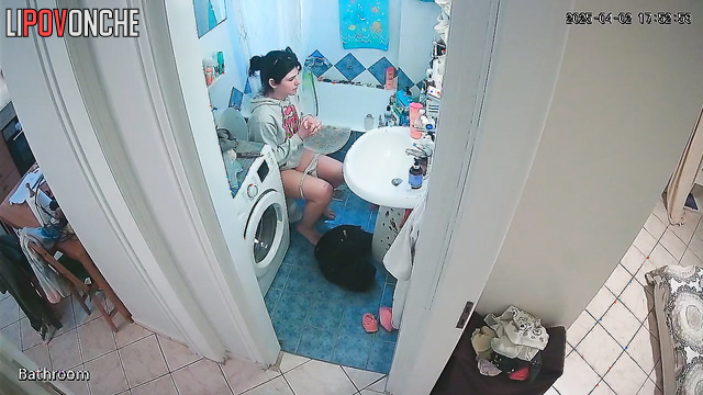 A cute girl pulls down her panties and is completely focused on peeing
