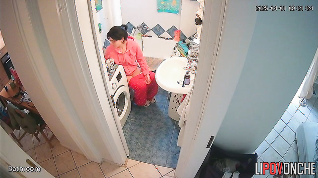 Brunette takes her time putting on her panties after using the restroom