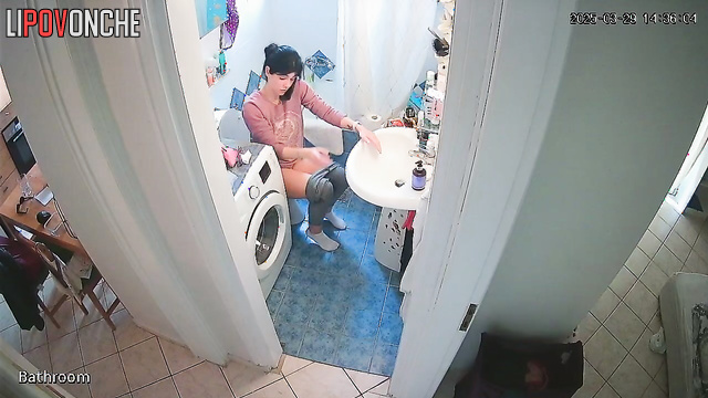 A cute housewife is chatting on the phone while peeing in the toilet