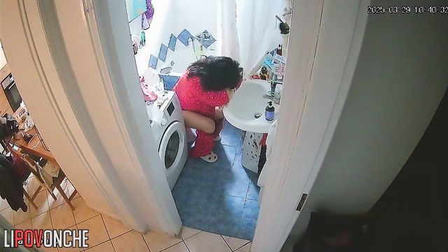 A tired brunette almost fell asleep while sitting and peeing on the toilet