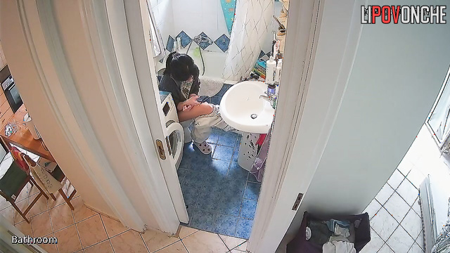 A gorgeous girl is watching porn on her phone while sitting on the toilet
