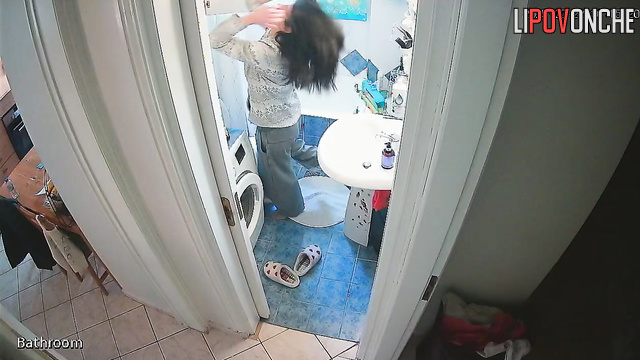 Brunette completely bares her alluring body as she gets ready to take a shower
