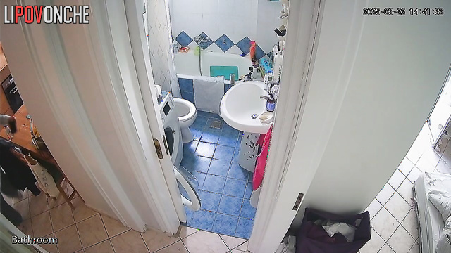 A housewife feeling under the weather sits on the toilet, phone in hand