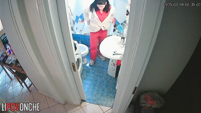 A young housewife brushes her teeth without getting up from the toilet