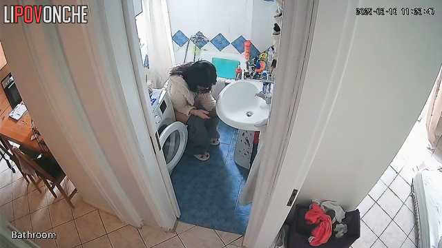 Sitting on the toilet, the housewife pulls her panties down lower and lower