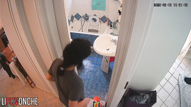 A nice brunette with her panties pulled down pees while standing