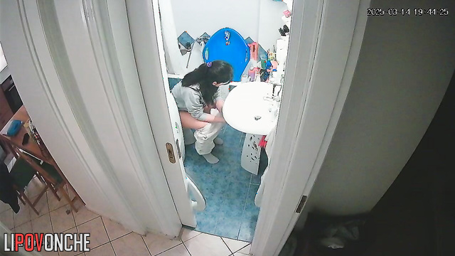 After washing her hands, a delightful cutie pulls down her panties to pee