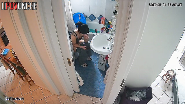 After cleaning the apartment, the cute brunette bares her sexy ass in the restroom