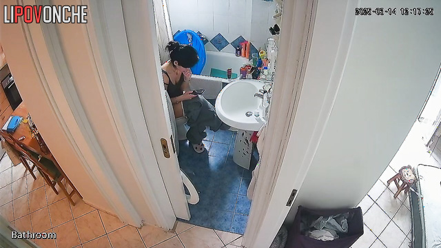 After cleaning the apartment, the cute brunette bares her sexy ass in the restroom