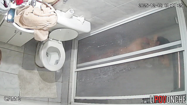A tattooed blonde undressing in the shower has no idea she's being filmed