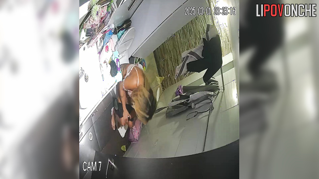 A half-asleep blonde checks her messages on her smartwatch while peeing