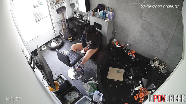 A stunning brunette bares her big butt and sits on a fancy toilet