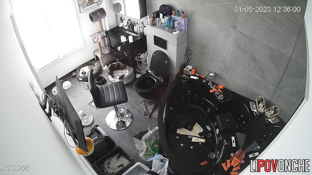 A pretty mommy with a voluptuous naked body is fixing her hair in front of the mirror