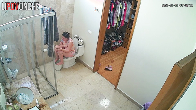 Pulling on a light dress, mommy looks at her naked body in the mirror