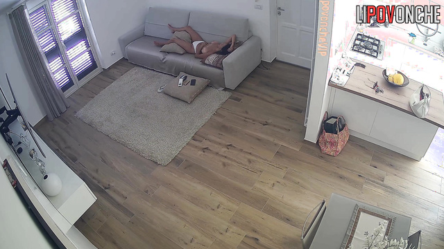 Couple taking turns relaxing on the sofa, hidden cam